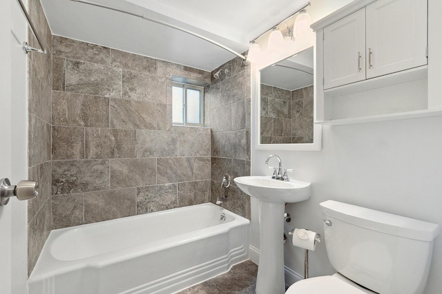 bathroom featuring a sink, toilet, and shower / tub combination