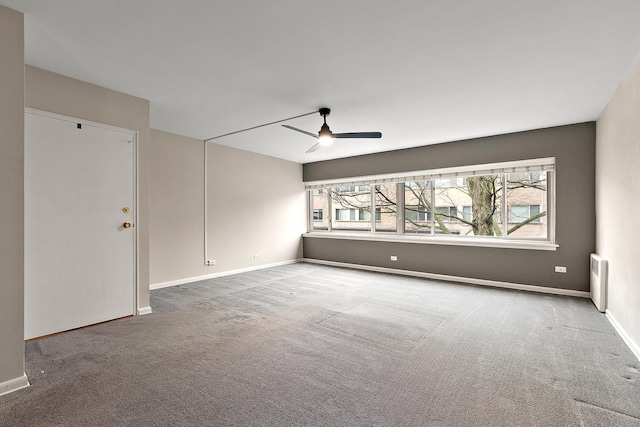 spare room with a wealth of natural light, baseboards, ceiling fan, and carpet