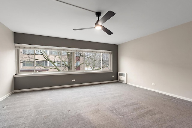 spare room featuring carpet floors, plenty of natural light, and baseboards