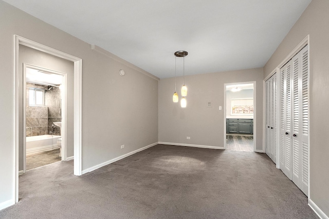 unfurnished dining area featuring carpet flooring and baseboards