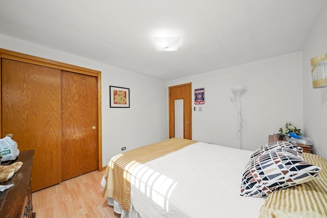 bedroom featuring light wood-type flooring and a closet