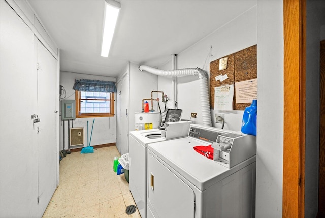 clothes washing area featuring light floors, water heater, and independent washer and dryer