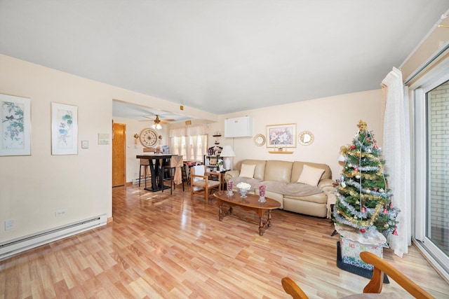 living area featuring light wood-type flooring and a baseboard radiator