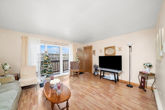 living area with light wood-style floors and baseboards