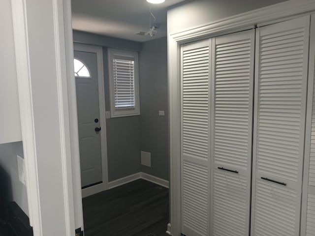 entrance foyer featuring baseboards and dark wood finished floors