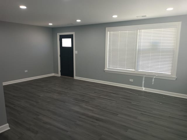 foyer with baseboards, dark wood finished floors, and recessed lighting