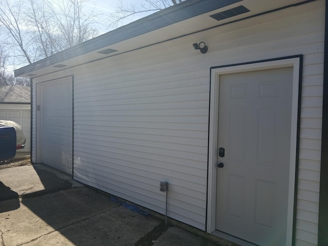 doorway to property with a garage