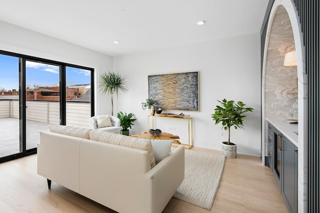 living room with light wood-style flooring and recessed lighting