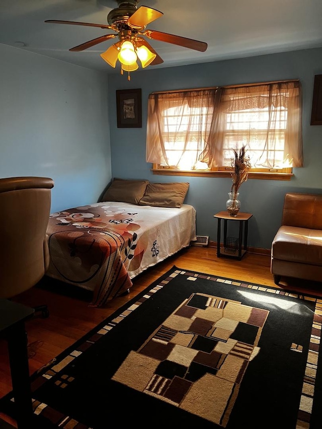 bedroom featuring ceiling fan and wood finished floors