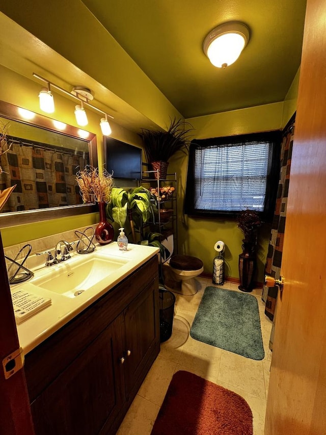 full bath featuring vanity and toilet