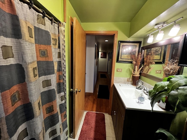 full bathroom featuring curtained shower, vanity, and tile patterned floors