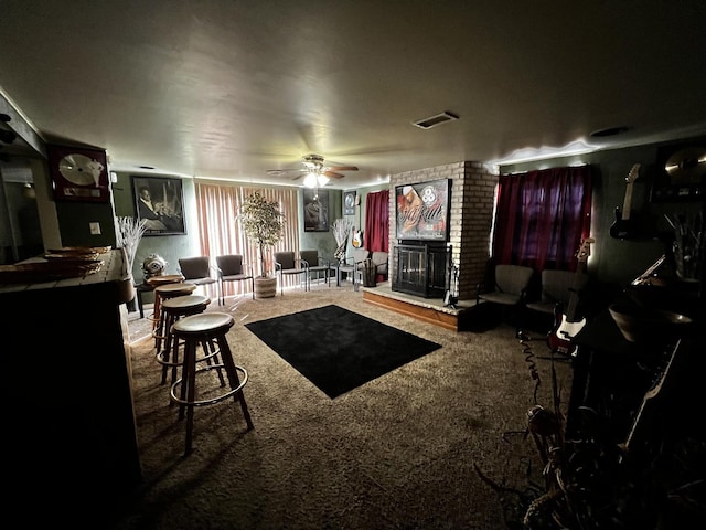 living room with carpet floors, visible vents, a fireplace, and a ceiling fan