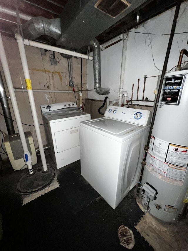 clothes washing area with water heater, laundry area, washer and clothes dryer, and visible vents