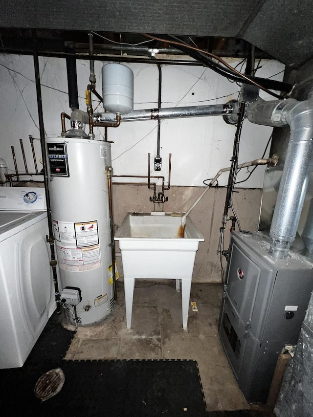 utilities featuring washer / clothes dryer and gas water heater