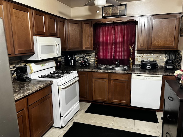 kitchen with white appliances, tasteful backsplash, ceiling fan, and a sink