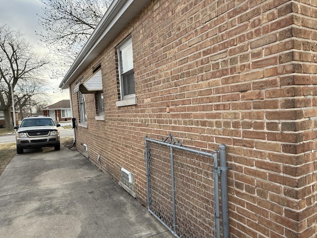 view of property exterior with brick siding and crawl space