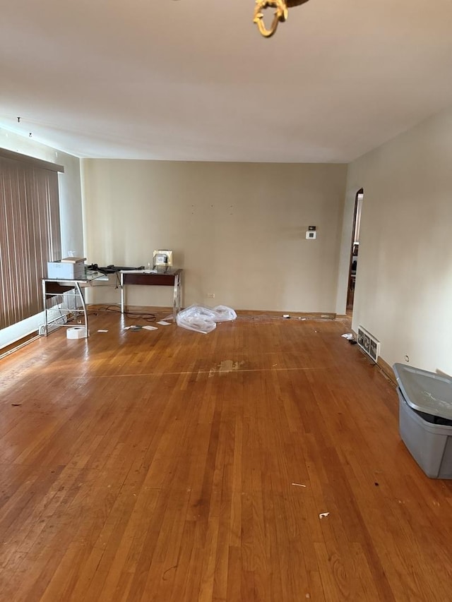 unfurnished room with hardwood / wood-style flooring