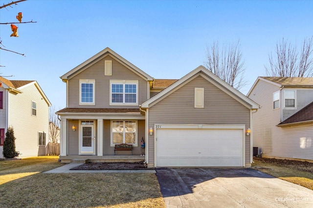 traditional-style house featuring a garage, a porch, concrete driveway, and a front yard