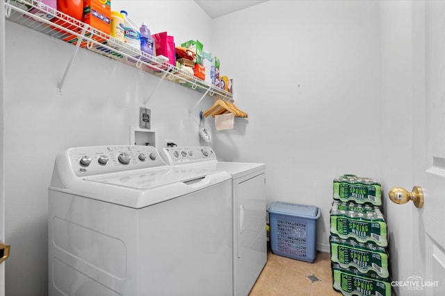 laundry area with washer and dryer, laundry area, and light tile patterned floors