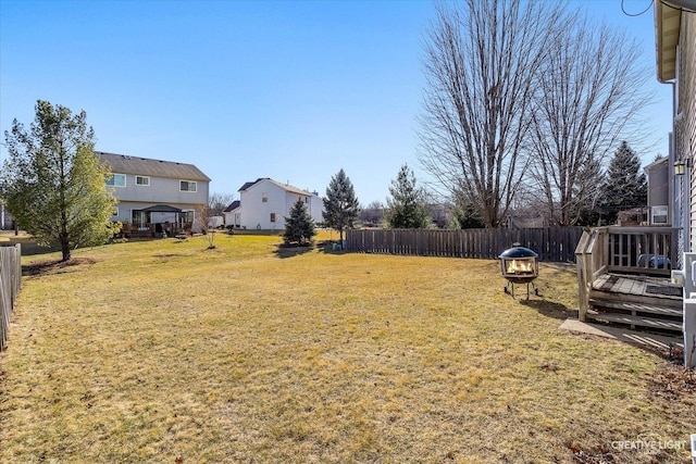 view of yard featuring a deck and fence