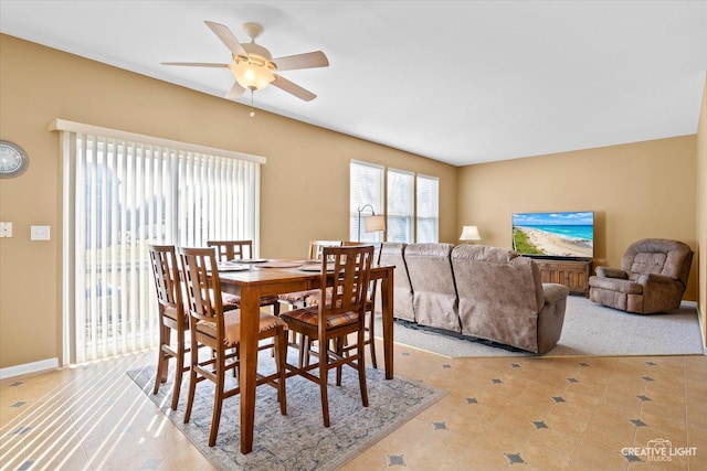 dining room with ceiling fan and baseboards