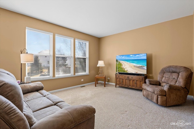 living room featuring carpet floors, visible vents, and baseboards