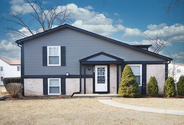 tri-level home with brick siding