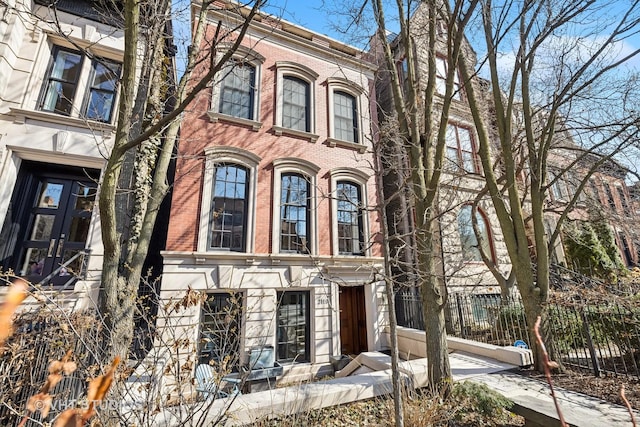 italianate home with fence and brick siding