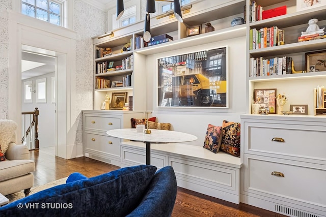 living area with plenty of natural light, dark wood-type flooring, and wallpapered walls