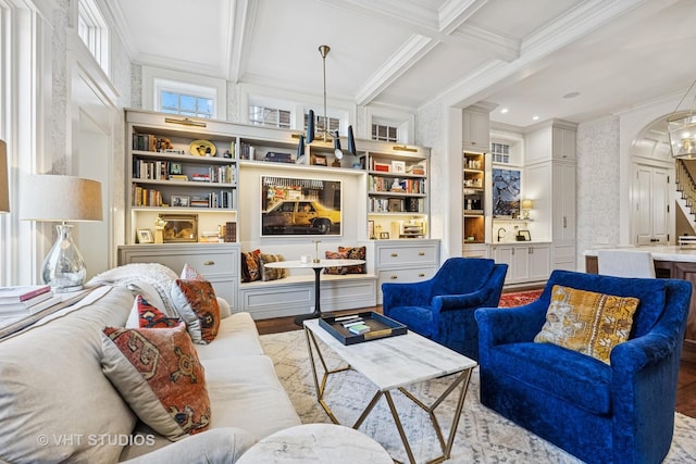 living area featuring wallpapered walls, crown molding, beamed ceiling, arched walkways, and coffered ceiling