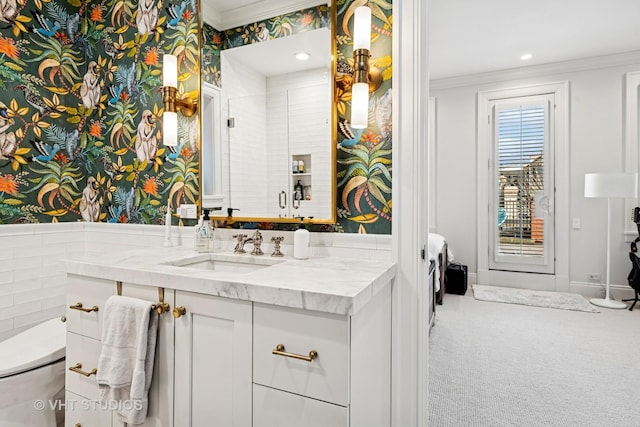 full bathroom featuring vanity, wallpapered walls, ornamental molding, a shower stall, and toilet