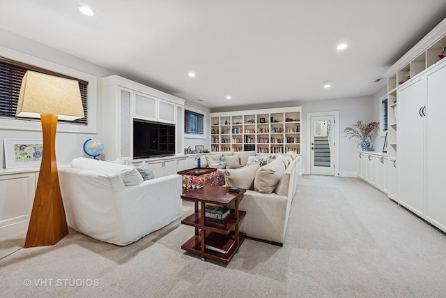 living area with light carpet, recessed lighting, and baseboards