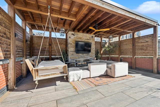 view of patio featuring an outdoor living space with a fireplace