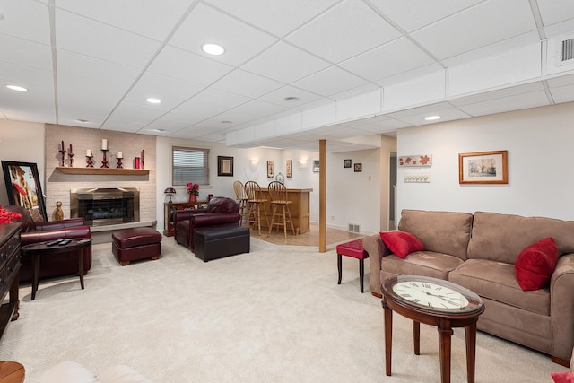 living area with visible vents, light colored carpet, a bar, a fireplace, and recessed lighting