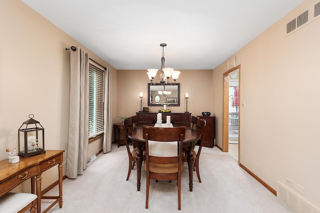 dining space featuring an inviting chandelier, baseboards, visible vents, and light colored carpet