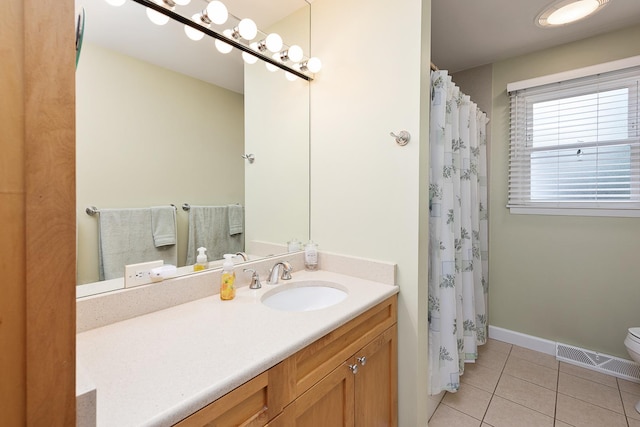 full bath featuring toilet, visible vents, baseboards, vanity, and tile patterned floors