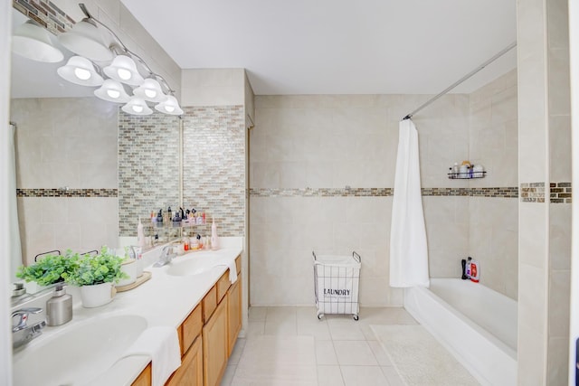 full bath featuring shower / bathtub combination with curtain, tile patterned flooring, a sink, and tile walls