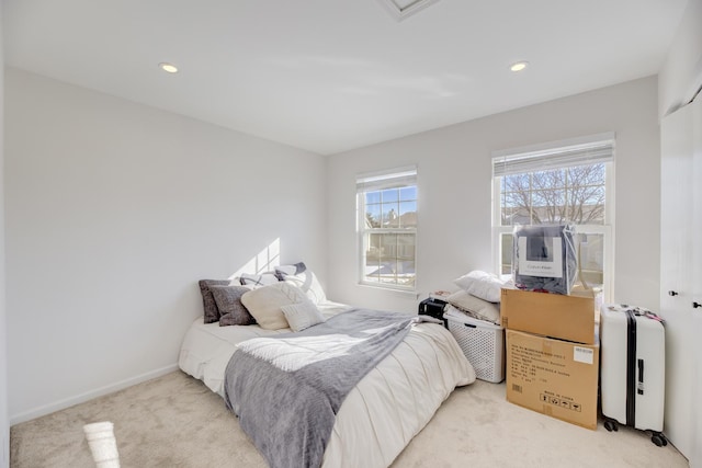 bedroom with recessed lighting, light carpet, and baseboards