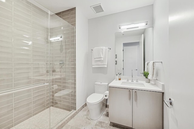 bathroom featuring visible vents, a shower stall, baseboards, toilet, and vanity