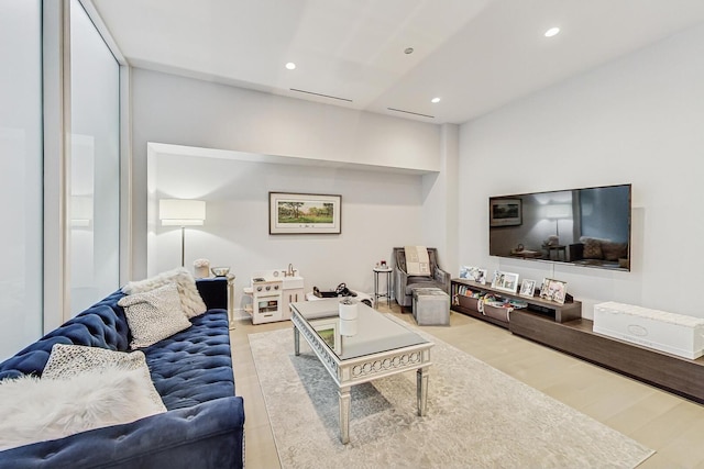 living room with recessed lighting and wood finished floors