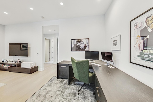 office space featuring recessed lighting, baseboards, and light wood finished floors