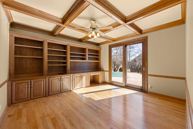 unfurnished office featuring beam ceiling, built in study area, light wood-type flooring, coffered ceiling, and baseboards