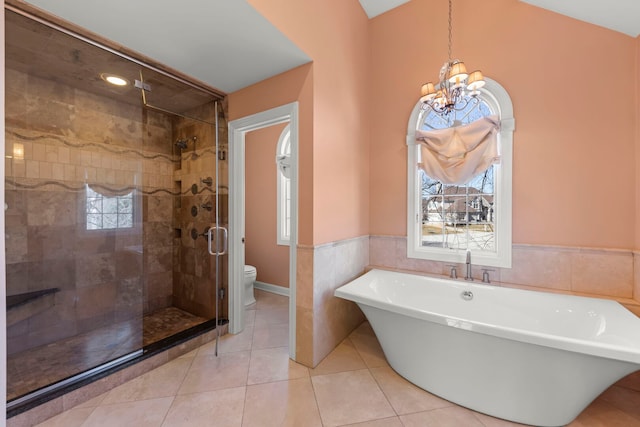 full bathroom with tile patterned flooring, a soaking tub, a healthy amount of sunlight, and a shower stall