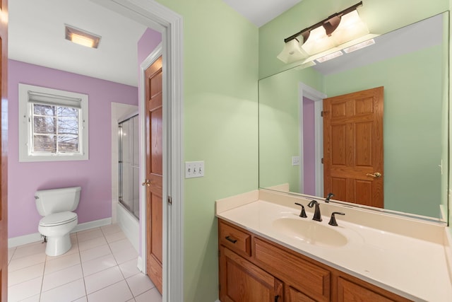 full bath with enclosed tub / shower combo, tile patterned flooring, toilet, vanity, and baseboards