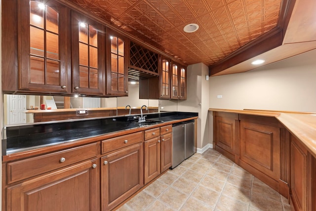 kitchen featuring an ornate ceiling, a sink, stainless steel dishwasher, dark countertops, and glass insert cabinets