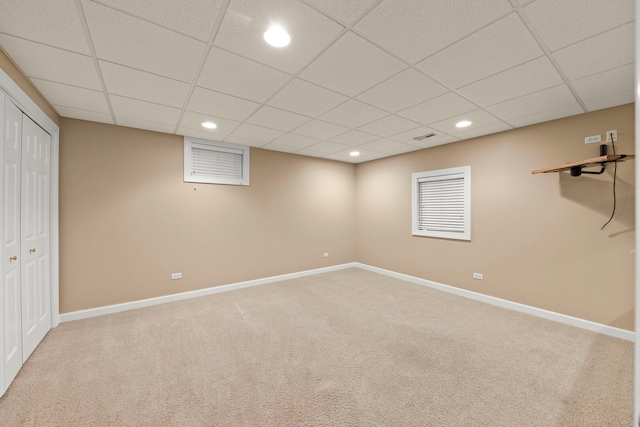 finished basement featuring recessed lighting, a paneled ceiling, visible vents, carpet flooring, and baseboards