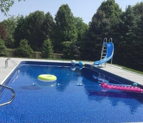 pool featuring a patio and a water slide