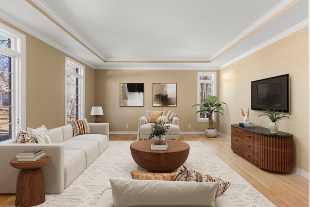 living room with light wood-style floors, a wealth of natural light, and baseboards