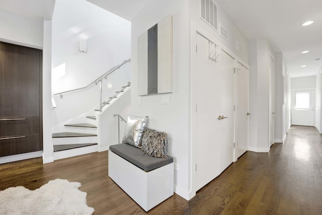 corridor featuring stairs, recessed lighting, visible vents, and wood finished floors