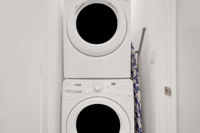 laundry area with stacked washer and dryer and laundry area